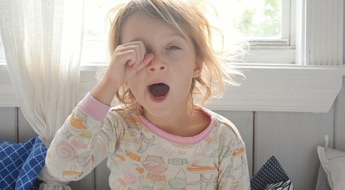 Young girl yawning in pajamas, Better Sleep Council
